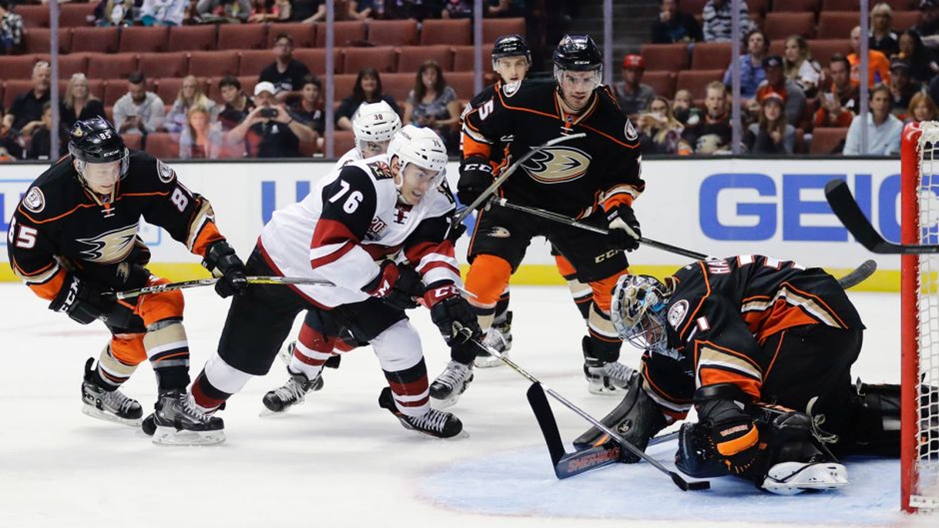 Anaheim Ducks goalie Matthew Hackett, right, stops a shot by Arizona Coyotes' Laurent Dauphin (76) during the first period of an NHL preseason hockey game, Tuesday, Sept. 27, 2016, in Anaheim, Calif. (AP Photo/Jae C. Hong)