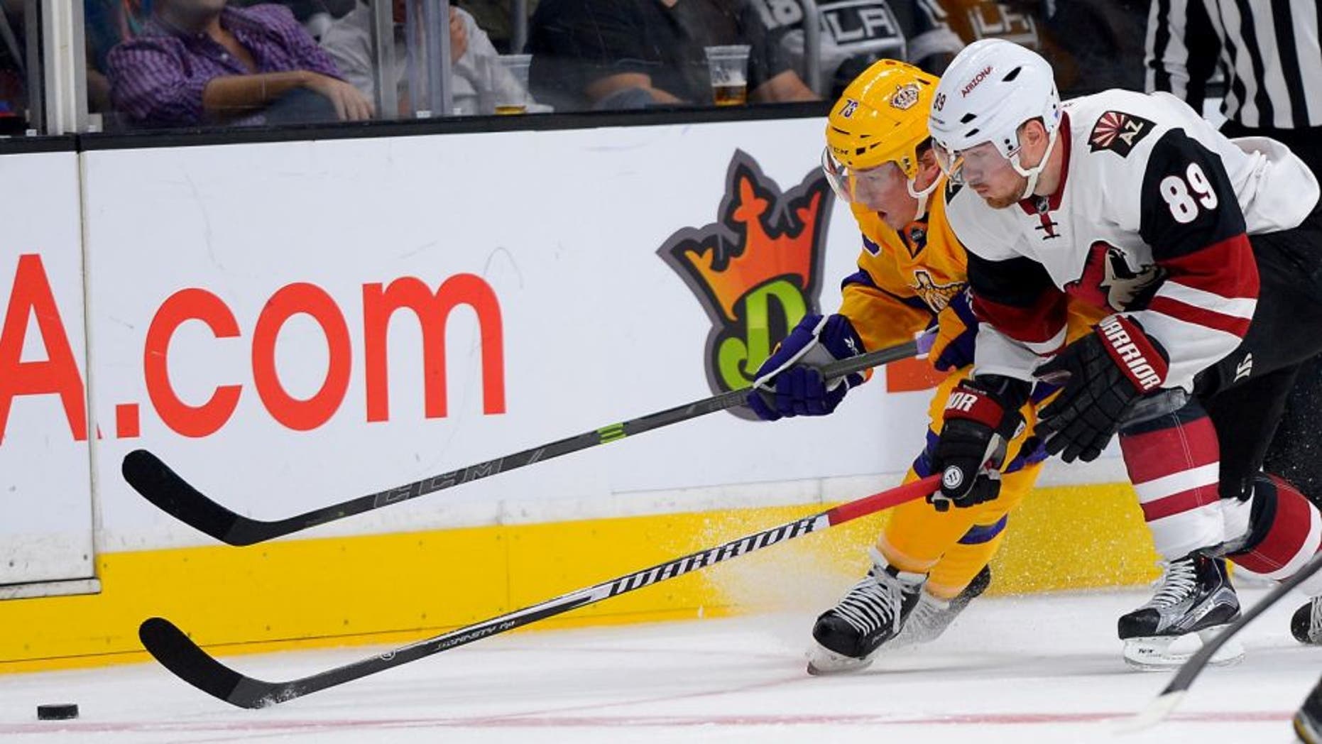 Nov 10, 2015; Los Angeles, CA, USA; Arizona Coyotes left wing Mikkel Boedker (89) and Los Angeles Kings center Tyler Toffoli (73) chase down the puck in the second period of the game at Staples Center. Mandatory Credit: Jayne Kamin-Oncea-USA TODAY Sports