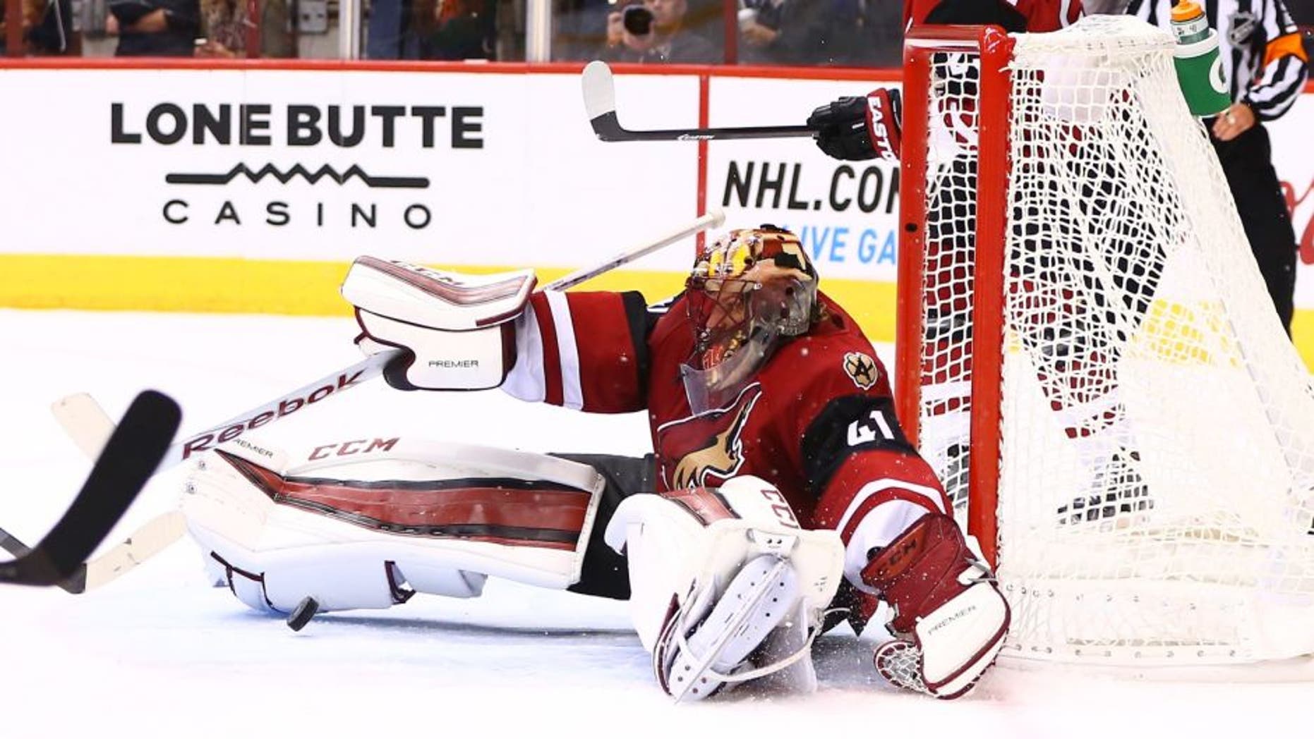 Oct 10, 2015; Glendale, AZ, USA; Arizona Coyotes goalie Mike Smith makes a save in the third period against the Pittsburgh Penguins during the home opener at Gila River Arena. The Coyotes defeated the Penguins 2-1. Mandatory Credit: Mark J. Rebilas-USA TODAY Sports