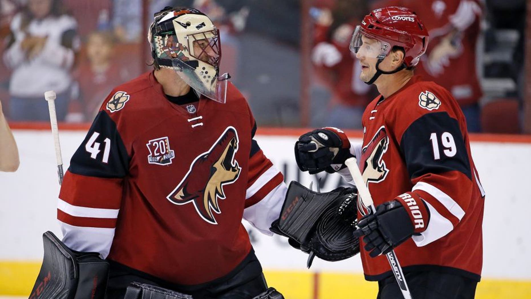 Arizona Coyotes' Mike Smith (41) and Shane Doan (19) celebrate the Coyotes' 3-1 win over the San Jose Sharks in an NHL preseason hockey game Friday, Oct. 7, 2016, in Glendale, Ariz. (AP Photo/Ross D. Franklin)
