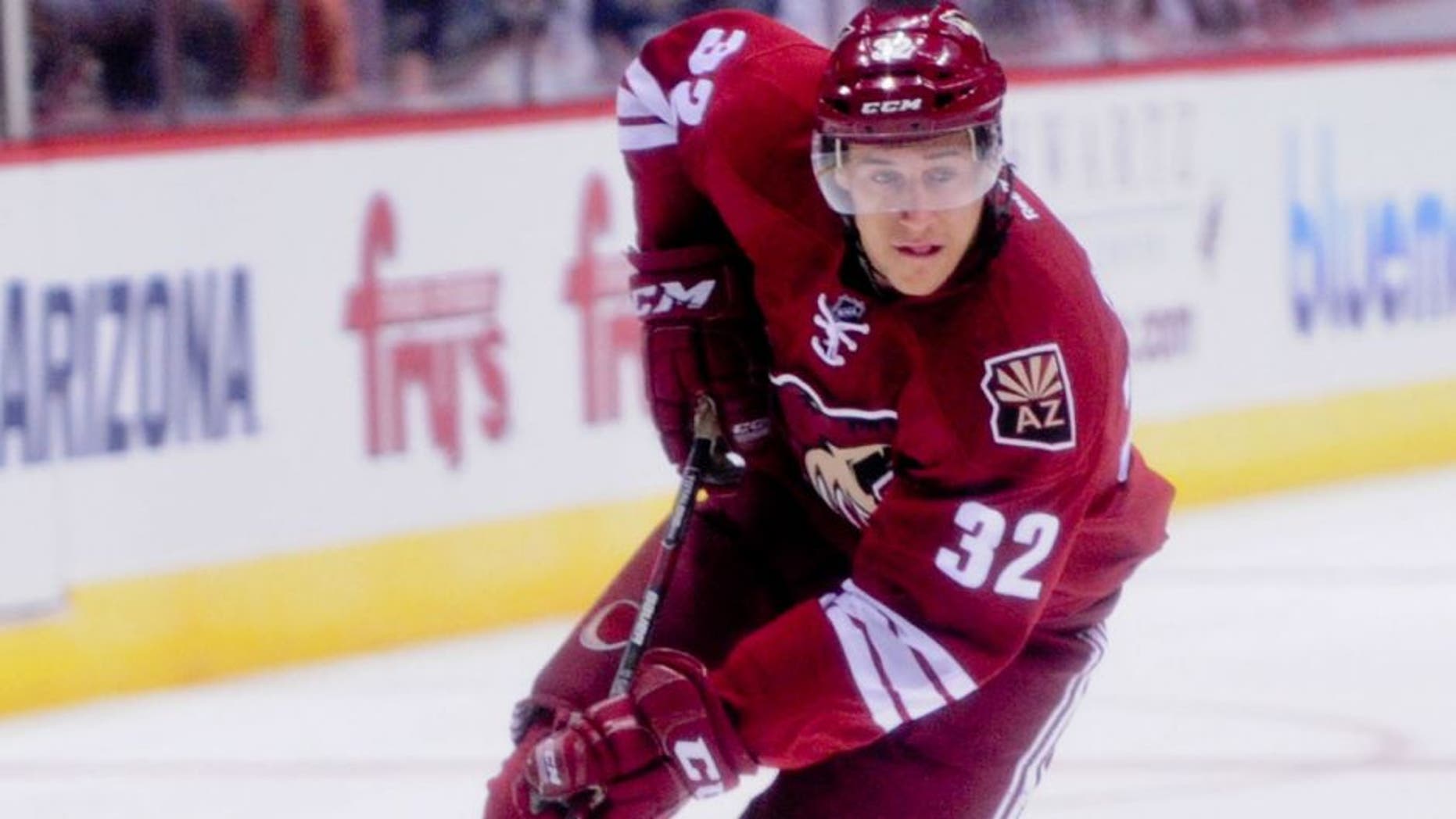 Sep 22, 2014; Glendale, AZ, USA; Arizona Coyotes center Tyler Gaudet (32) carries the puck during the first period against the Los Angeles Kings at Gila River Arena. Mandatory Credit: Matt Kartozian-USA TODAY Sports