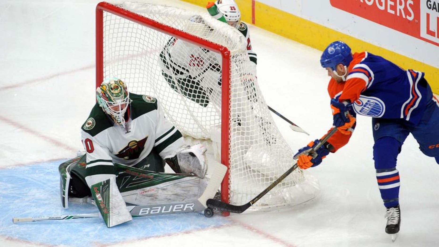Dec 4, 2016; Edmonton, Alberta, CAN; Edmonton Oilers right winger Zack Kassian (44) tries to get the puck past Minnesota Wild goalie Devan Dubnyk (40) as Wild center defenceman Jonas Brodin (25) looks on during the first period at Rogers Place. Mandatory Credit: Walter Tychnowicz-USA TODAY Sports