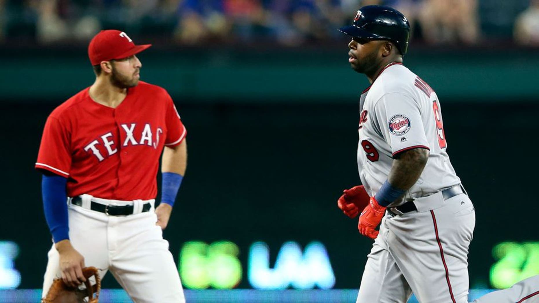 Apr 25, 2017; Arlington, TX, USA; Minnesota Twins designated hitter Kennys Vargas (19) rounds the bases in front of Texas Rangers third baseman Joey Gallo (13) after hitting a home run during the fourth inning at Globe Life Park in Arlington. Mandatory Credit: Kevin Jairaj-USA TODAY Sports
