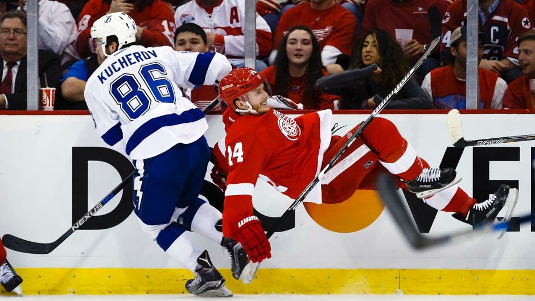Apr 19, 2016; Detroit, MI, USA; Tampa Bay Lightning right wing Nikita Kucherov (86) checks Detroit Red Wings center Gustav Nyquist (14) during the second period in game four of the first round of the 2016 Stanley Cup Playoffs at Joe Louis Arena. Mandatory Credit: Rick Osentoski-USA TODAY Sports