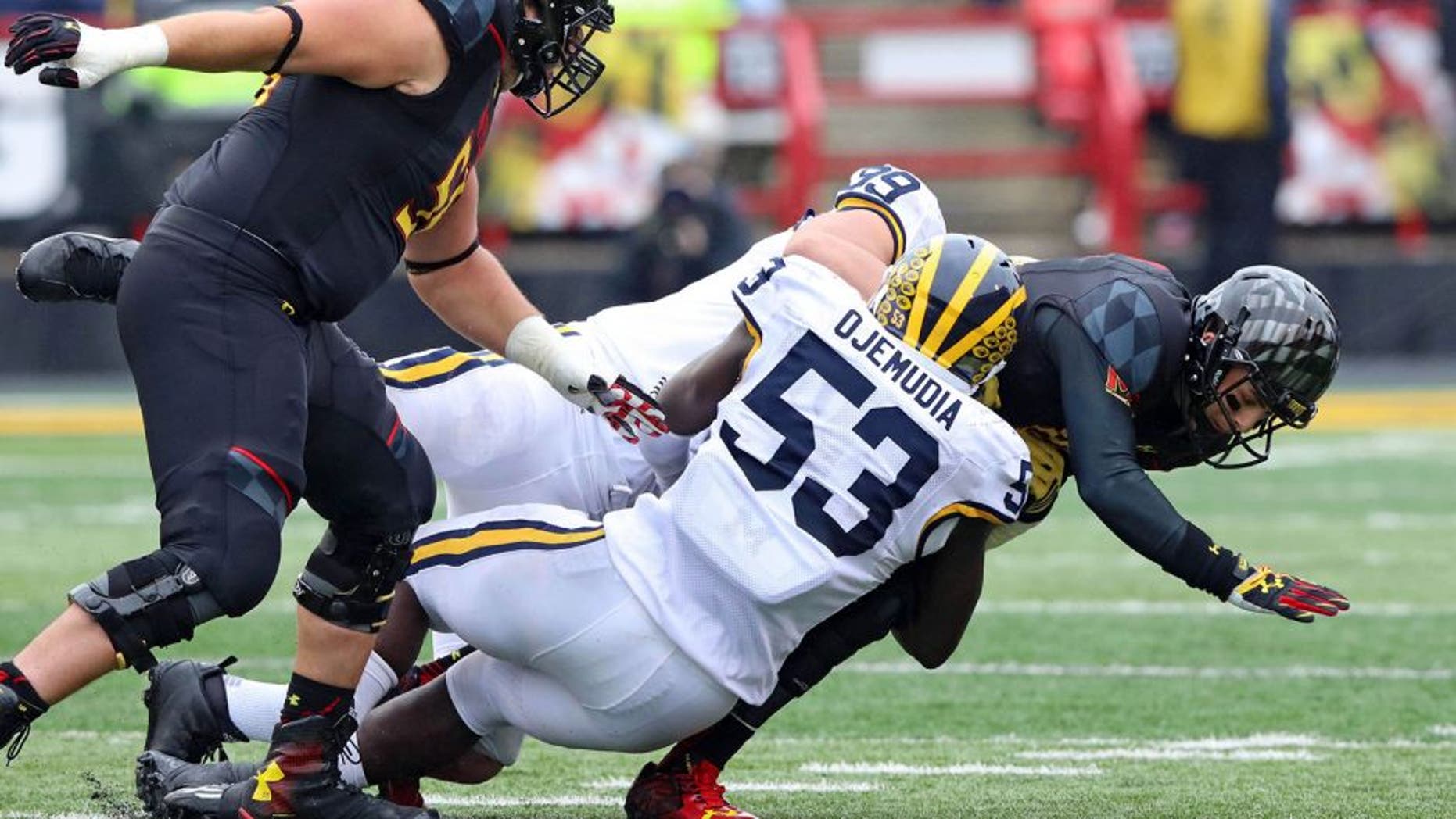 Oct 3, 2015; College Park, MD, USA; Maryland Terrapins quarterback Daxx Garman (18) is sacked by Michigan Wolverines defensive end Mario Ojemudia (53) at Byrd Stadium. Mandatory Credit: Mitch Stringer-USA TODAY Sports