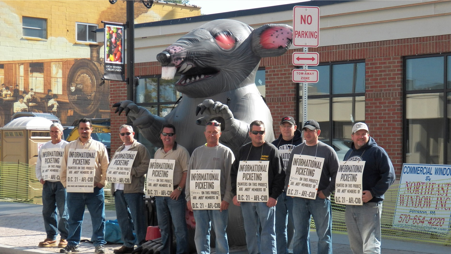 Members of the International Union of Painters and Allied Trades picket in front of the construction site of a new credit union banking location in Pittston, PA that is using non-union labor.