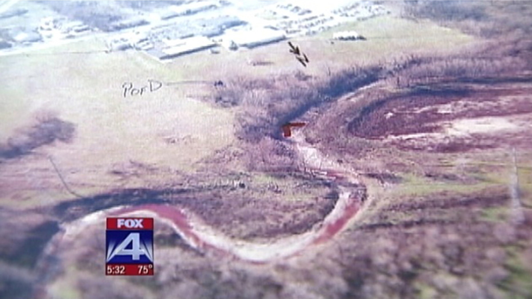 Jan. 20: This aerial photo taken by the Dallas County health department shows what appears to be pig's blood flowing in a creek close to the Columbia Packing company in Dallas.