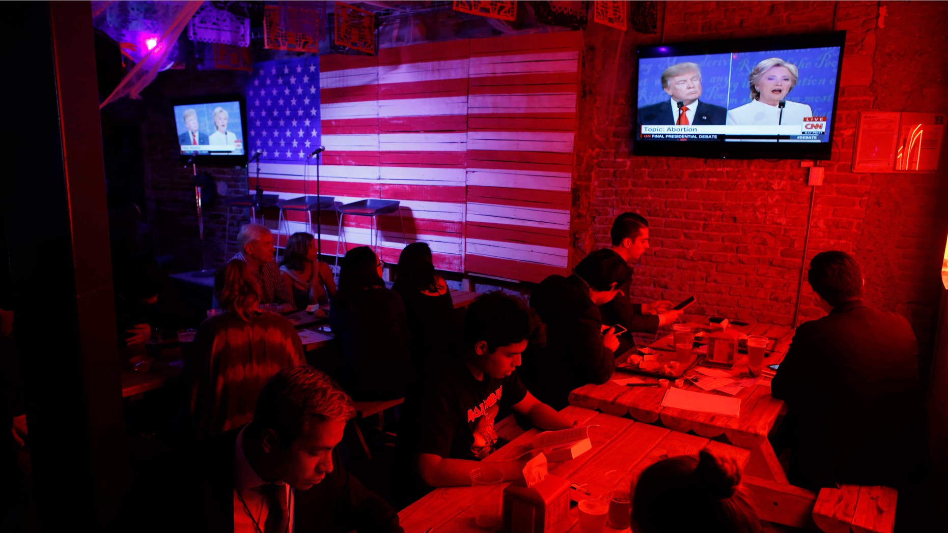 Customers watch the third presidential debate at the Pinche Gringo BBQ restaurant in Mexico City, on Oct. 19, 2016.