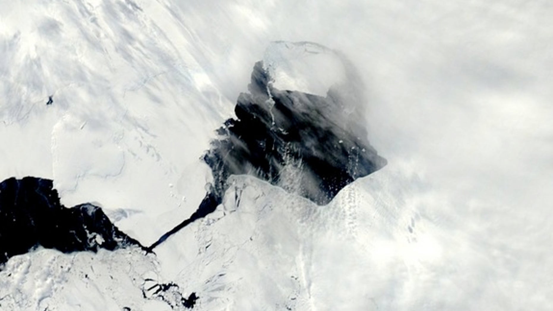 A NASA satellite image snapped Nov. 13, 2013, shows open water between Pine Island Glacier and its massive iceberg.