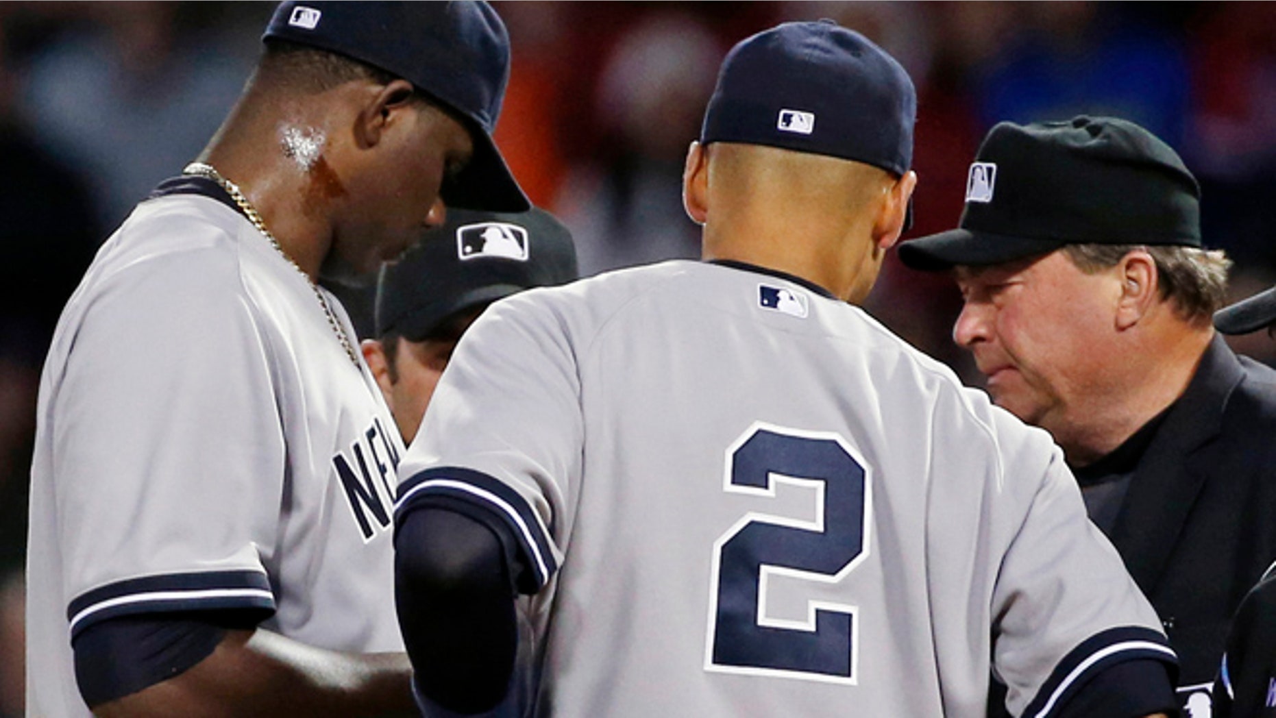 April 23, 2014: Home plate umpire Gerry Davis, right, confers on the mound with New York Yankees starting pitcher Michael Pineda, left, and shortstop Derek Jeter, center, and others in the second inning of a baseball game against the Boston Red Sox at Fenway Park in Boston.