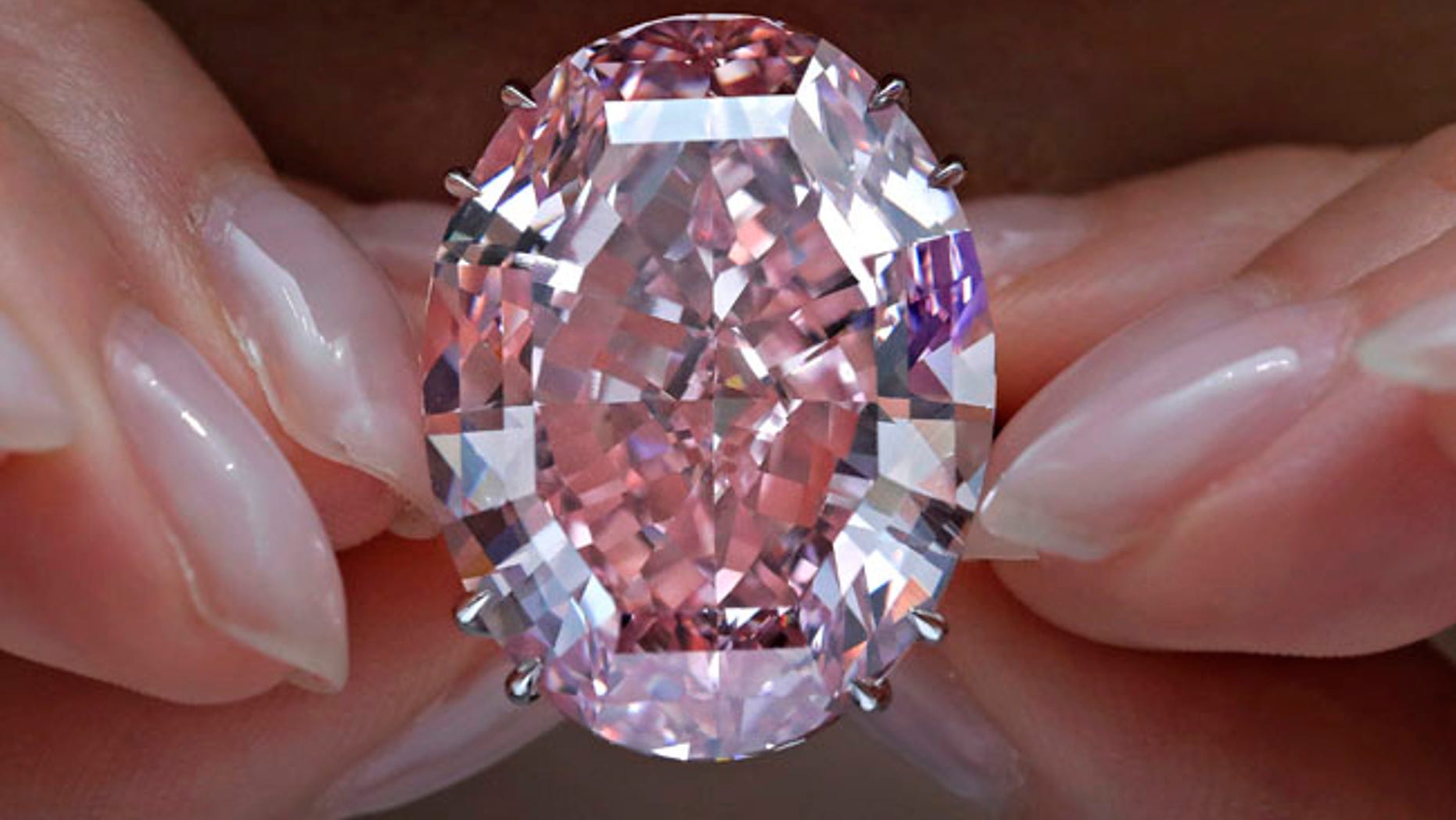 The "Pink Star" diamond, the most valuable cut diamond ever offered at auction, is displayed by a model at a Sotheby's auction room in Hong Kong. The stunning 59.6 carat diamond has sold for $71.2 million at auction, a record price.