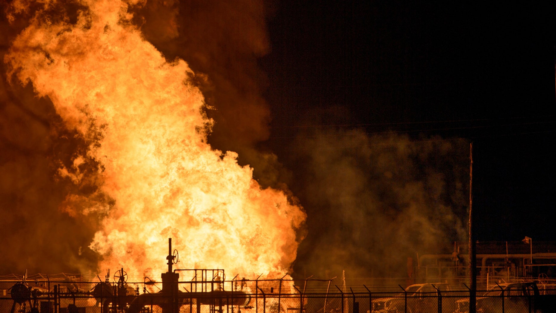 Vehicles and a power pole smoke next to a fire at the Phillips 66 pipeline in Paradis, La. Thursday, Feb. 9, 2017.