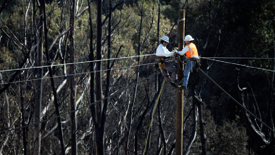 Line workers work to restore power at the site of a gas pipeline explosion in San Bruno, Calif., Monday, Sept. 13, 2010. (AP)