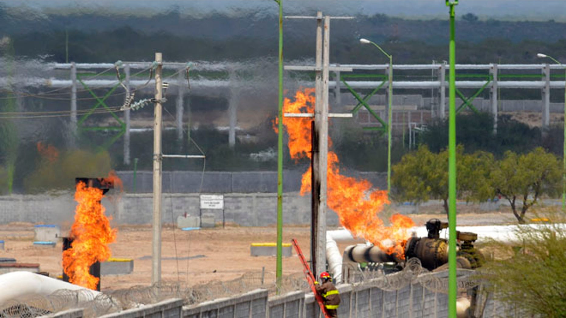 Sept. 18, 2012: Firefighter climb a ladder as they try to control a fire after an explosion at a gas pipeline distribution center in Reynosa, Mexico near Mexico's border with the United States.