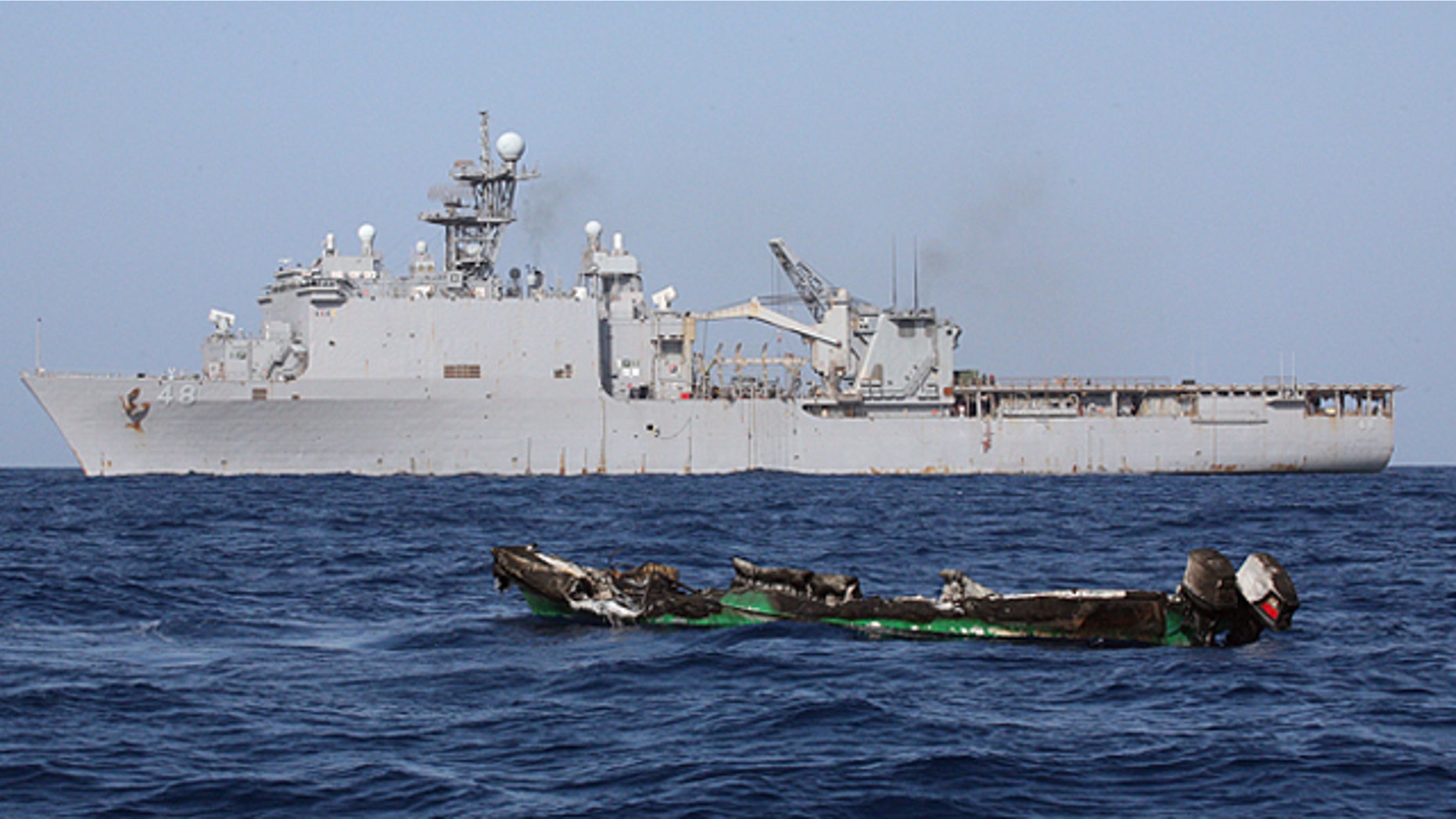 April 10: Suspected pirates skiff drifts at sea after being burnt the amphibious dock landing ship USS Ashland.