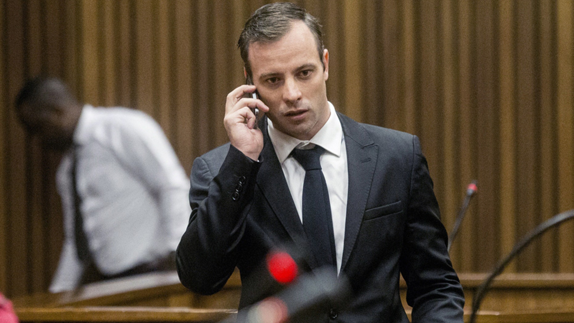 April 18, 2016: Oscar Pistorius talks on a mobile phone after a hearing at the High Court in Pretoria, South Africa.