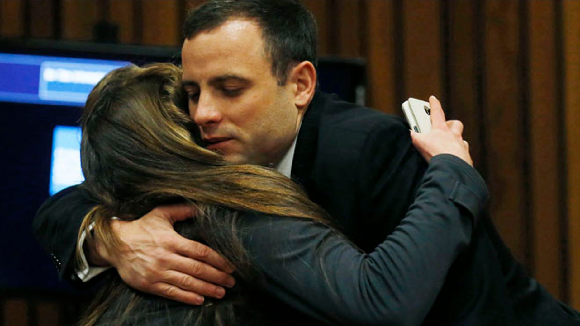 July 1, 2014: Oscar Pistorius is greeted by a well-wisher at a court in Pretoria, South Africa.