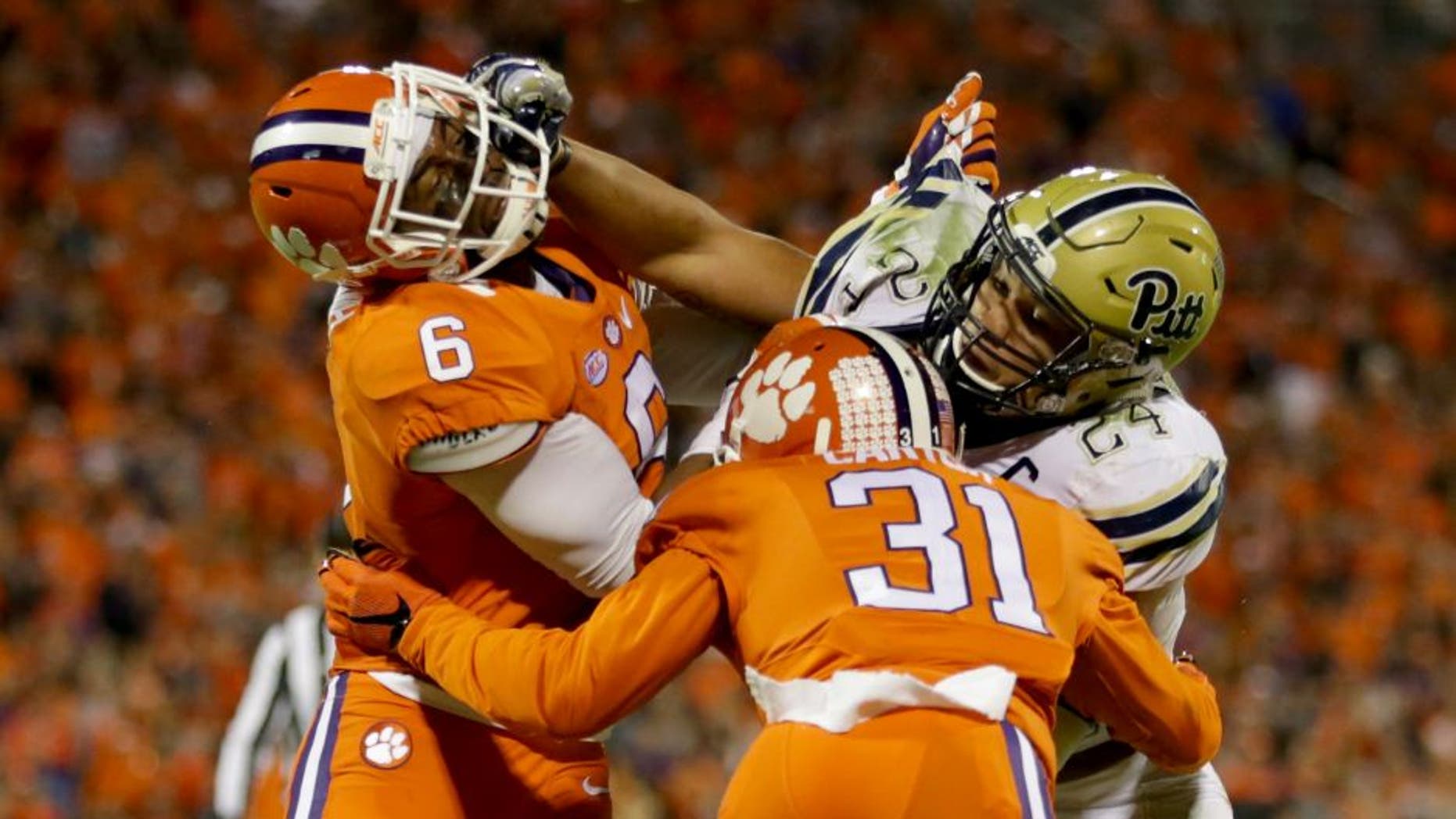 CLEMSON, SC - NOVEMBER 12: Teammates Dorian O'Daniel #6 and Ryan Carter #31 of the Clemson Tigers try to stop James Conner #24 of the Pittsburgh Panthers during their game at Memorial Stadium on November 12, 2016 in Clemson, South Carolina. (Photo by Streeter Lecka/Getty Images)