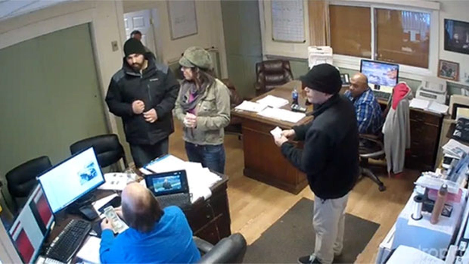 Security footage show pizza delivery man Jarrid Tansey inside a Massachusetts car dealership office.