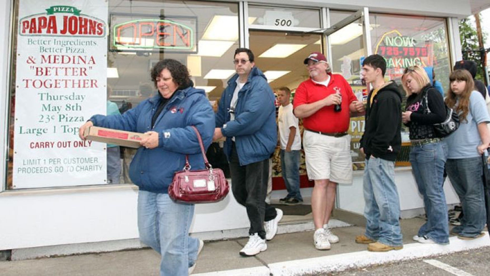FILE: People leave a Papa John's store with pizzas they purchased for 23 cents in Medina Ohio