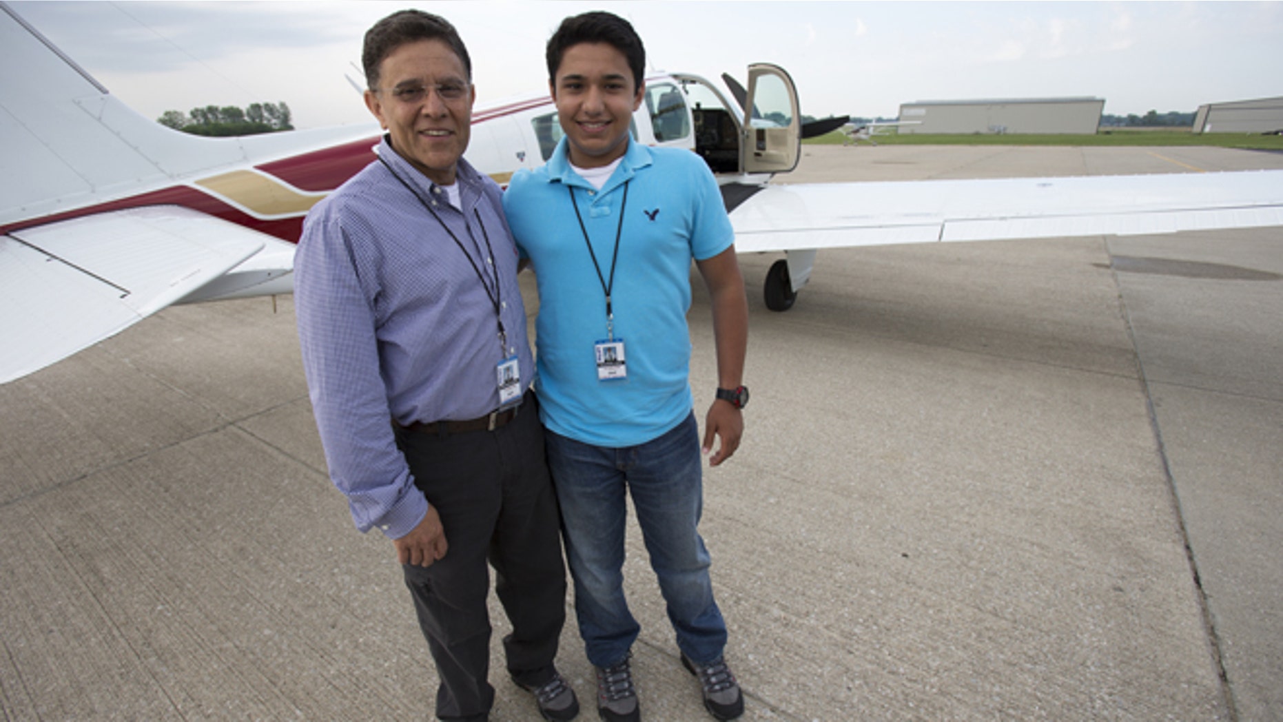 June 19, 2014: Babar Suleman and son Haris Suleman, 17, stand next to their plane at an airport in Greenwood, Ind. before taking off for an around-the-world flight. (AP/The Indianapolis Star)