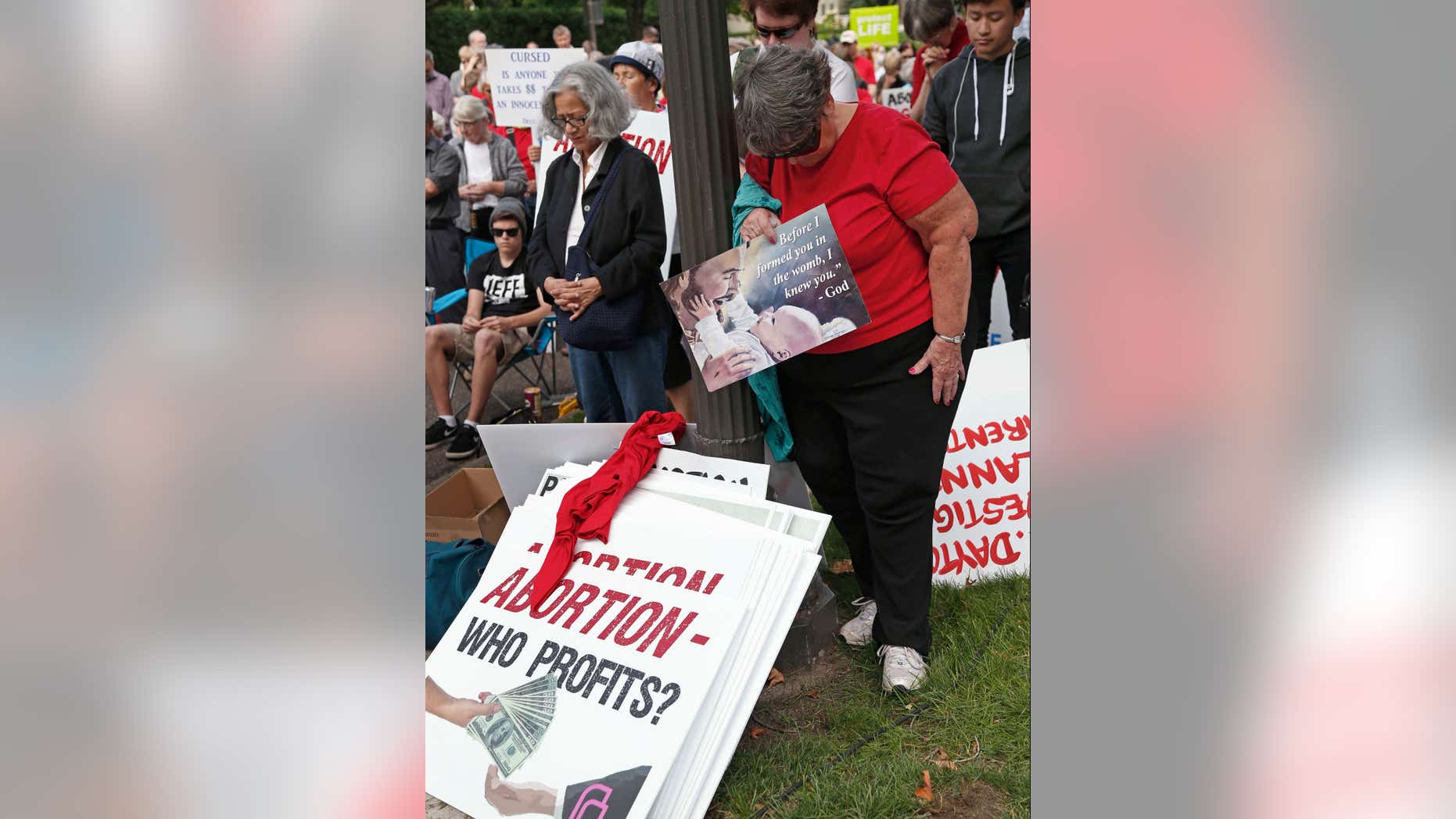 Sept. 9, 2015: People bow their heads during a prayer as hundreds of demonstrators gather outside the governor's mansion in St. Paul, Minn. in a protest calling for Governor Mark Dayton to defund and investigate Planned Parenthood. (AP Photo/Jim Mone)
