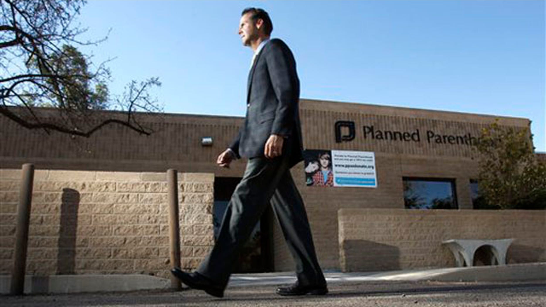 In this Jan. 23 photo, Bryan Howard, CEO of Planned Parenthood Arizona, walks in front of a Planned Parenthood facility in Tucson, Ariz.