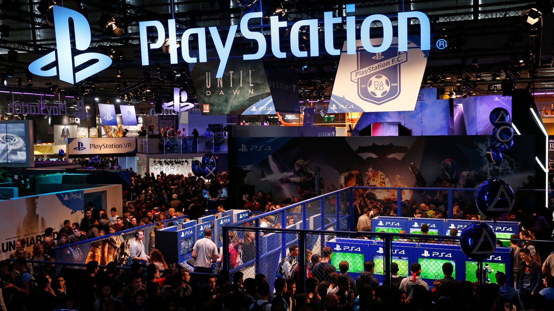 File photo - Visitors play games on PlayStation 4 (PS4) at the Paris Games Week, a trade fair for video games in Paris, France, October 28, 2015. (REUTERS/Benoit Tessier)