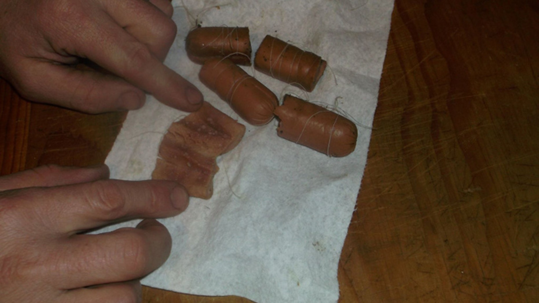 One of the hot dogs with an unknown substance inside.