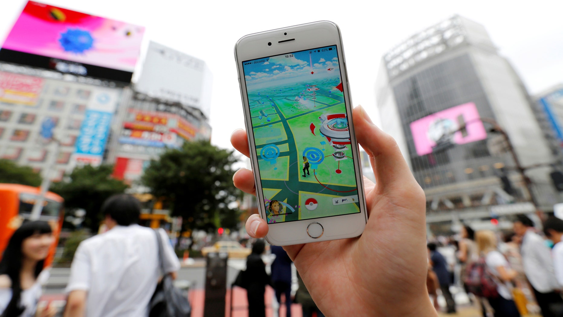 File photo - A man poses with his mobile phone displaying the augmented reality mobile game "Pokemon Go" by Nintendo in front of a busy crossing in Shibuya district in Tokyo, Japan, July 22, 2016. (REUTERS/Toru Hanai)