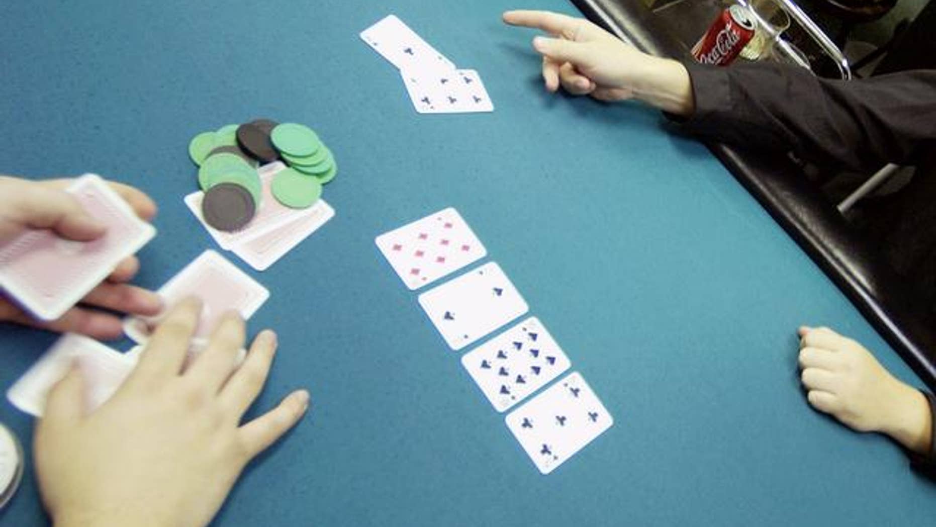 Player plays a hand at a poker club, New York. (AP)