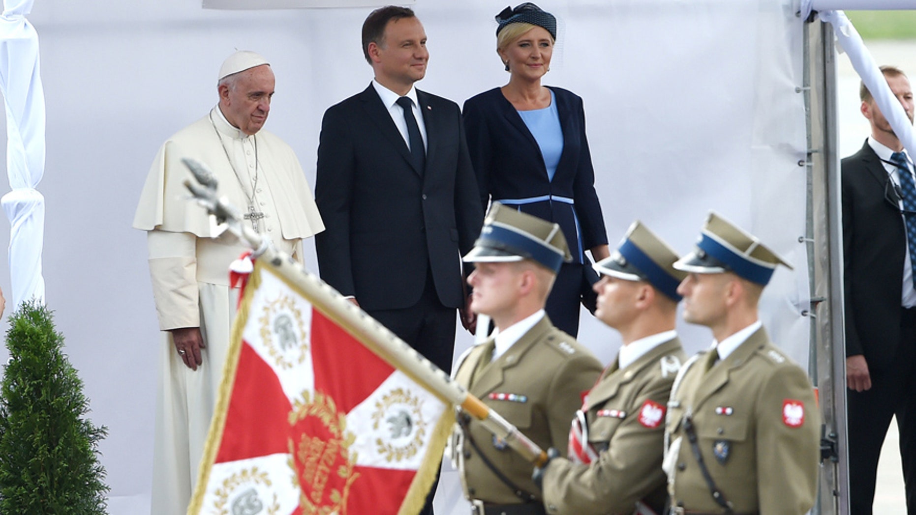 July 27, 2016: Pope Francis, with Polish President Andrzej Duda, center, and First Lady Agata Kornhauser-Duda watch attends the welcome ceremony upon his arrival at the military airport in Krakow, Poland.