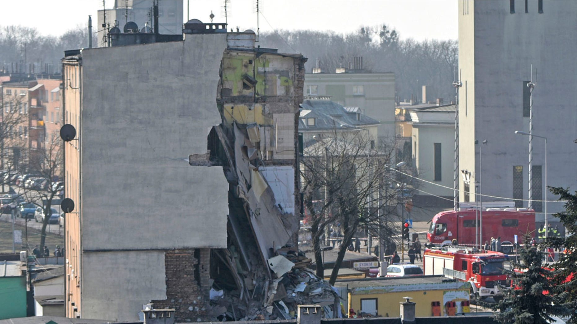 Rescuers work at a collapsed building in Poznan, Poland, Sunday, March 4, 2018.
