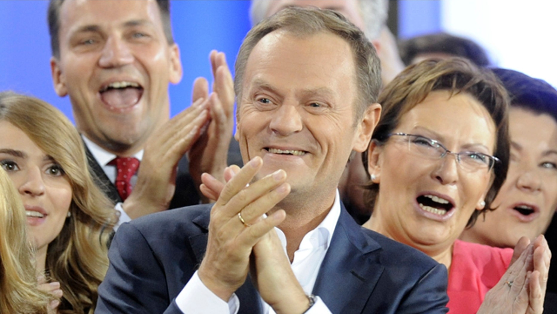 Oct. 9: Prime Minister Donald Tusk, center, celebrates with Health Minister Ewa Kopacz, right, and Foreign Minister Radek Sikorski, background left, as the first exit poll is published during the election party of Tusk's Civic Platform, a centrist and pro-EU party, in Warsaw.