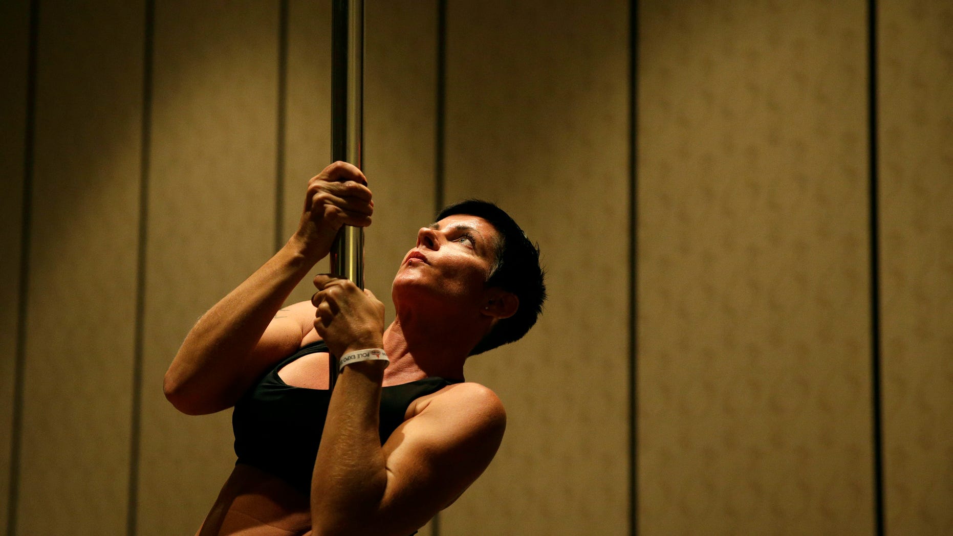 In this Sept. 7, 2014 photo, Heidi Nilsson participates in a workshop at the Pole Expo in Las Vegas. (AP Photo/John Locher)