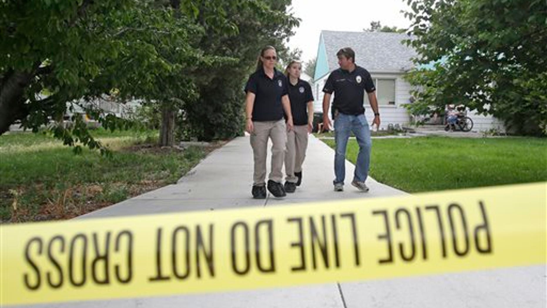 Police officials rope off a home during an investigation after a 12-year-old girl was found dead Friday, July 17, 2015, in West Valley City, Utah. The search for the missing 12-year-old girl is now being investigated as a homicide after West Valley City police discovered the girl's body in a horse pasture. Police Chief Lee Russo says the girl's mother approached two officers at a convenience store near their home around 1:30 a.m. Friday,July 17, 2015. She told officers her daughter had been missing since midnight. (AP Photo/Rick Bowmer)