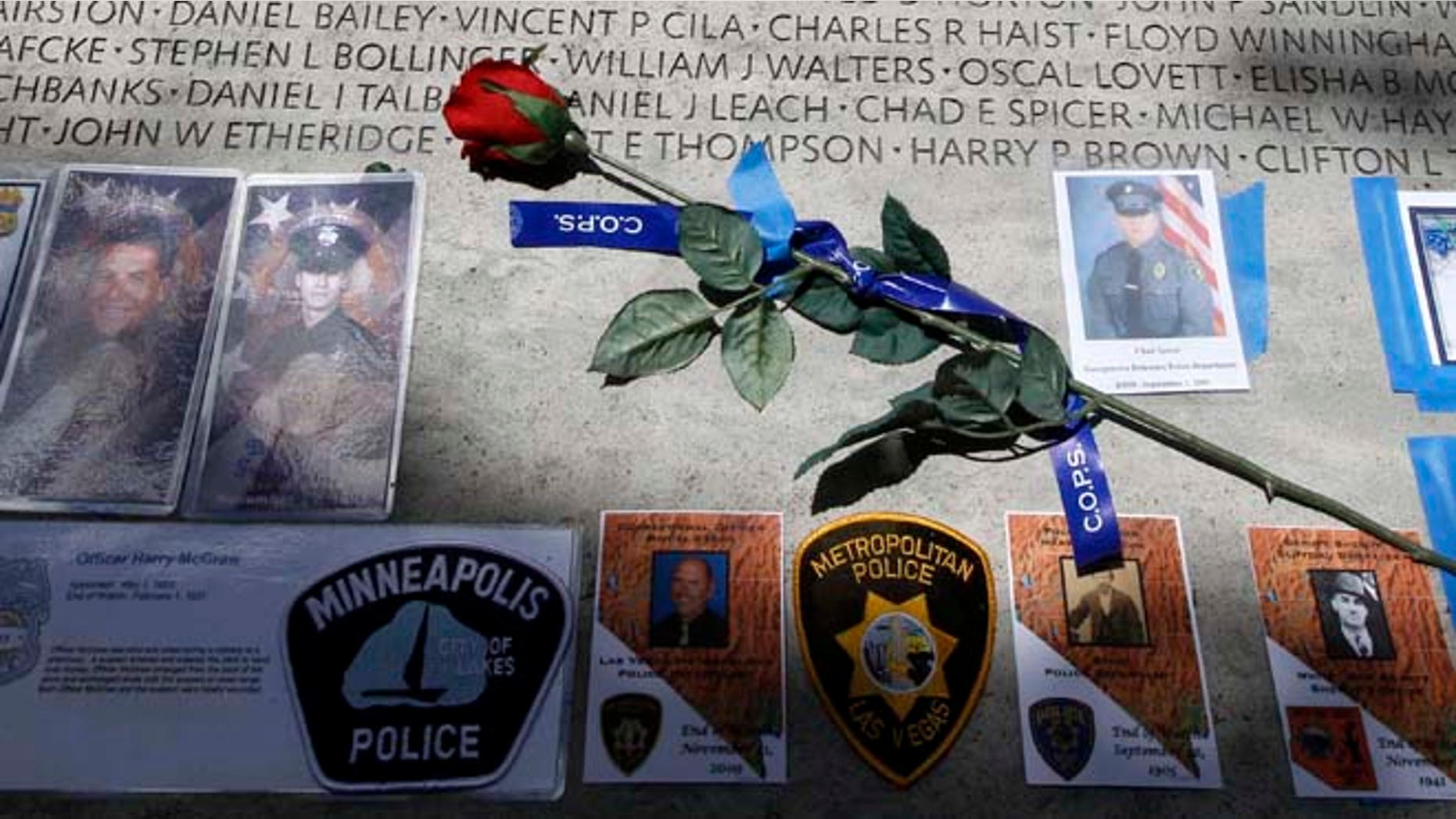 May 13, 2013: A rose is placed at the wall with the names of fallen police officers at the National Law Enforcement Officers Memorial in Washington during the National Police Week. The number of law enforcement officers killed by firearms in the U.S. jumped by 56 percent this year and included 15 ambush assaults, according to a report released Tuesday.
