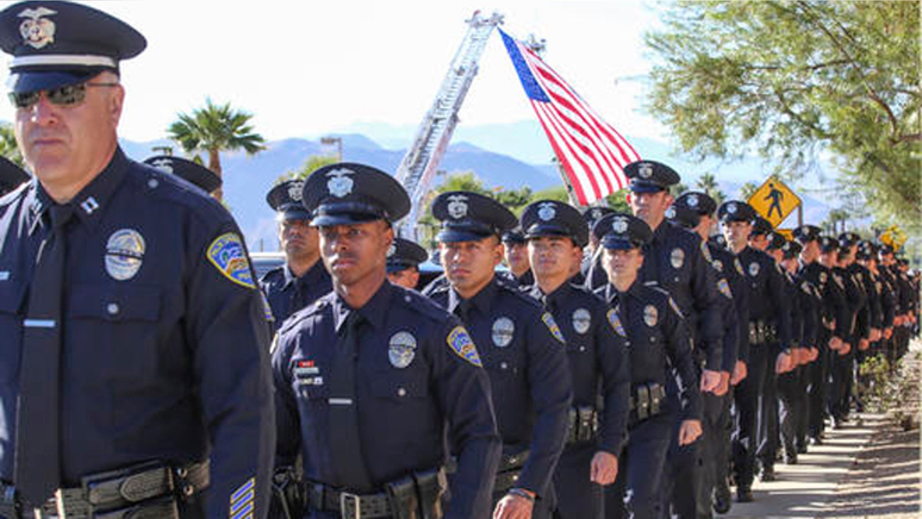 Members of the Palm Springs Police Department walk into the convention center for the services of Palm Springs officers Jose "Gil" Vega and Lesley Zerebny, the two officers who were killed in the line of duty earlier this month, Tuesday, Oct. 18, 2016. (Jay Calderon/The Desert Sun via AP)