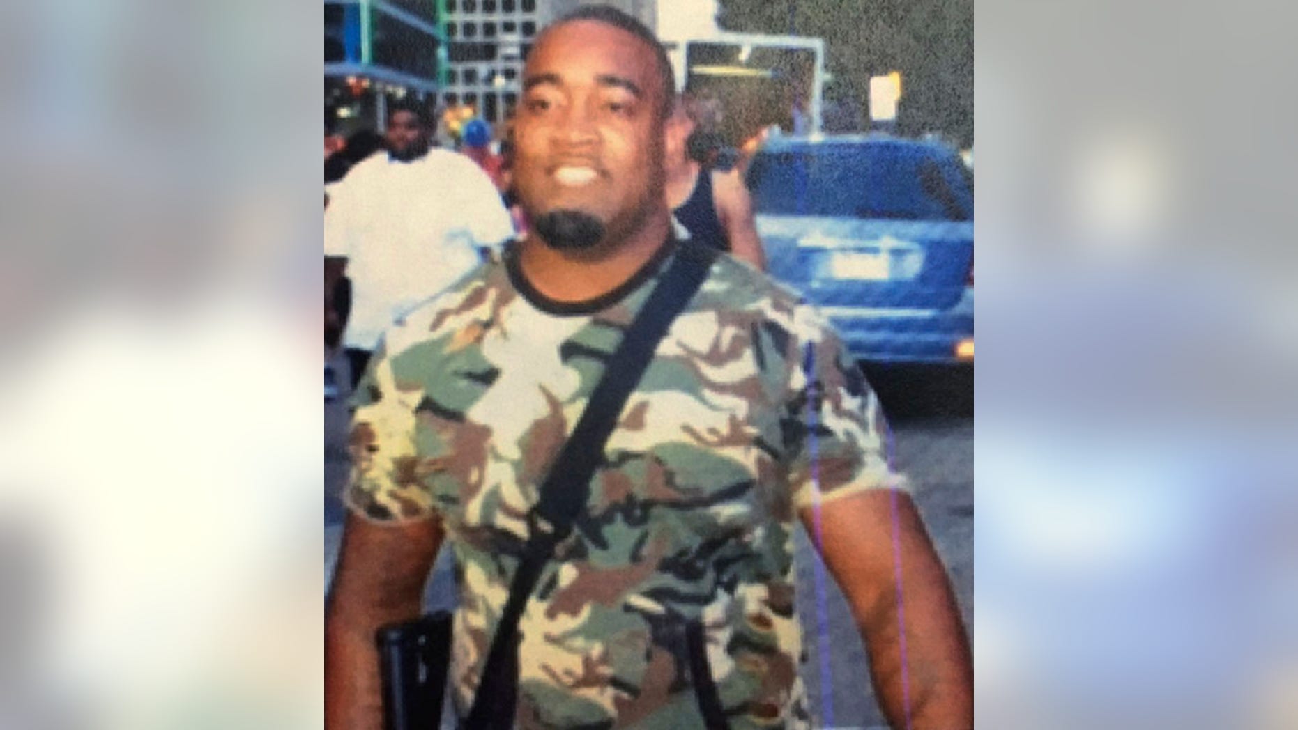 July 7, 2016: A photo provided by Dallas police shows open-carry activist Mark Hughes at a rally against excessive use of force by police in Dallas. Hughes says he was defamed by the Dallas Police Department, which tweeted the photo of him and described him as a suspect in the shootings of police officers.