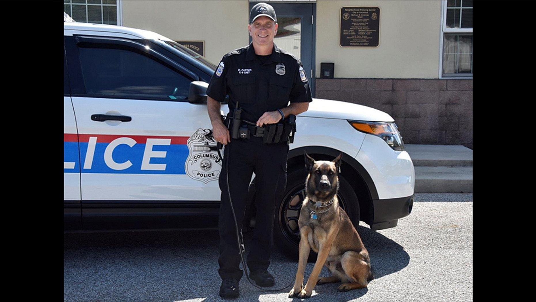 Brian Carter, an officer with the Columbus Police Department in Ohio, and his K9 partner Benzi in March 2018.