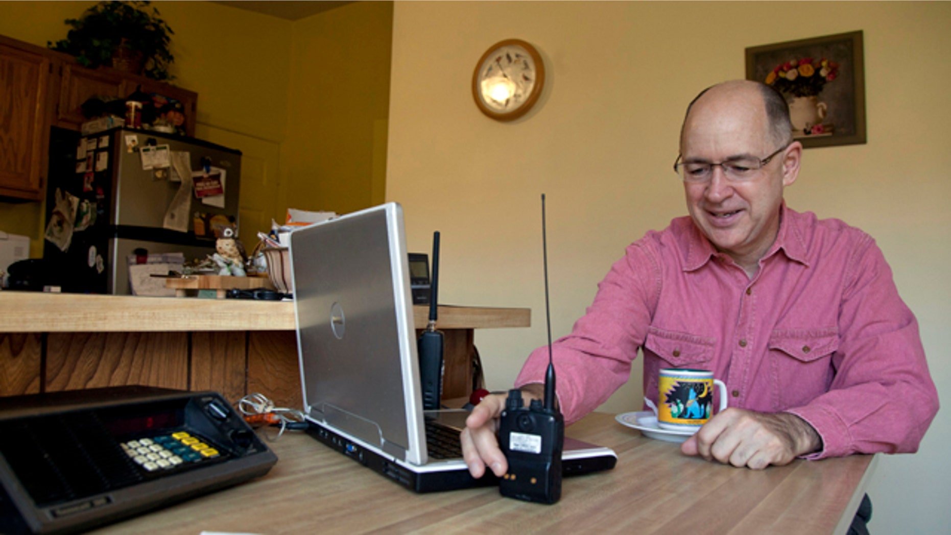 Nov. 19, 2011: Scanner hobbyist Rick Hansen holds his scanner/Ham radio device at his home in Silver Spring, Md.
