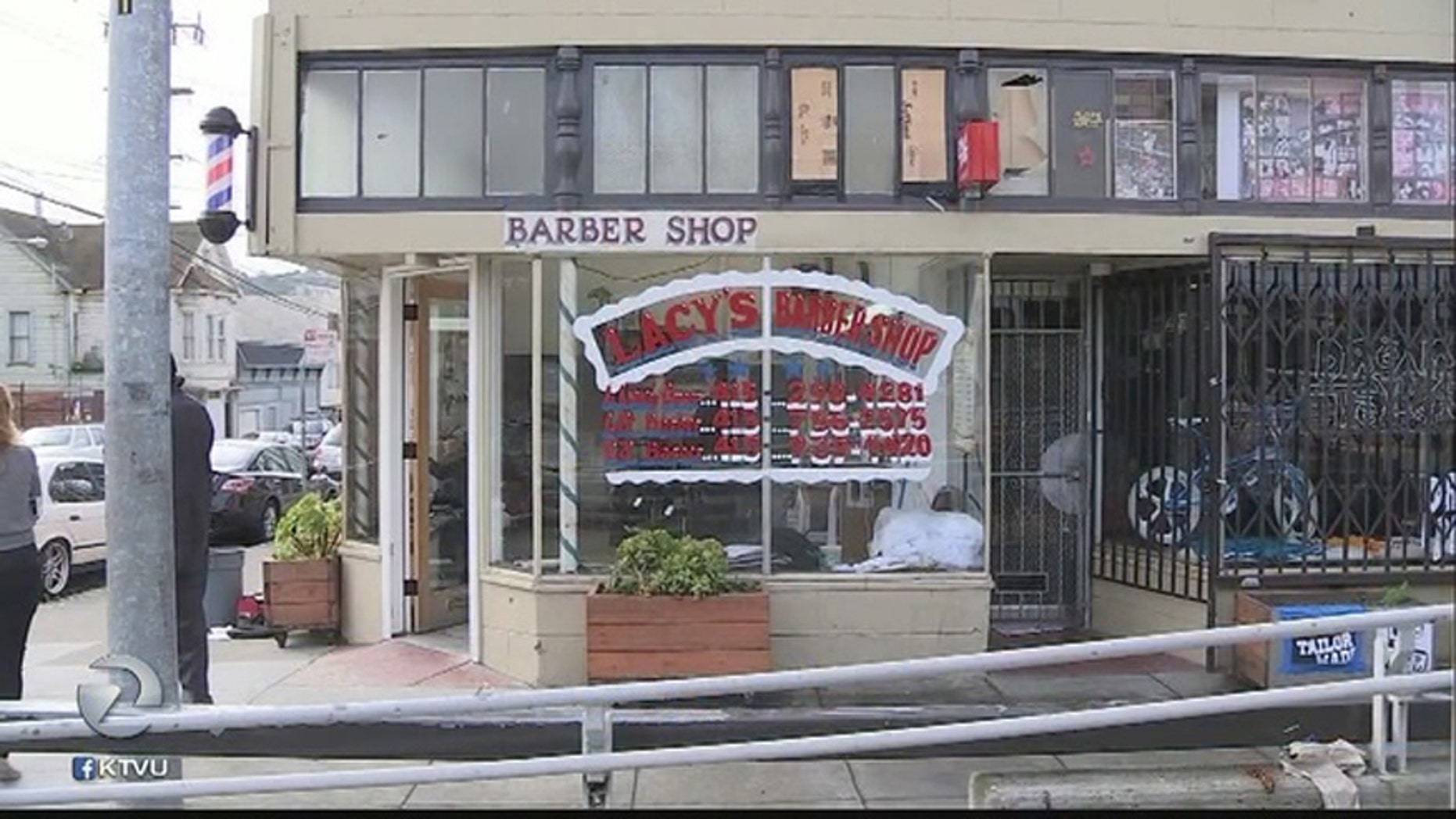 Lacy's Barberhshop, whose windows were shattered during a recently deadly shooting.