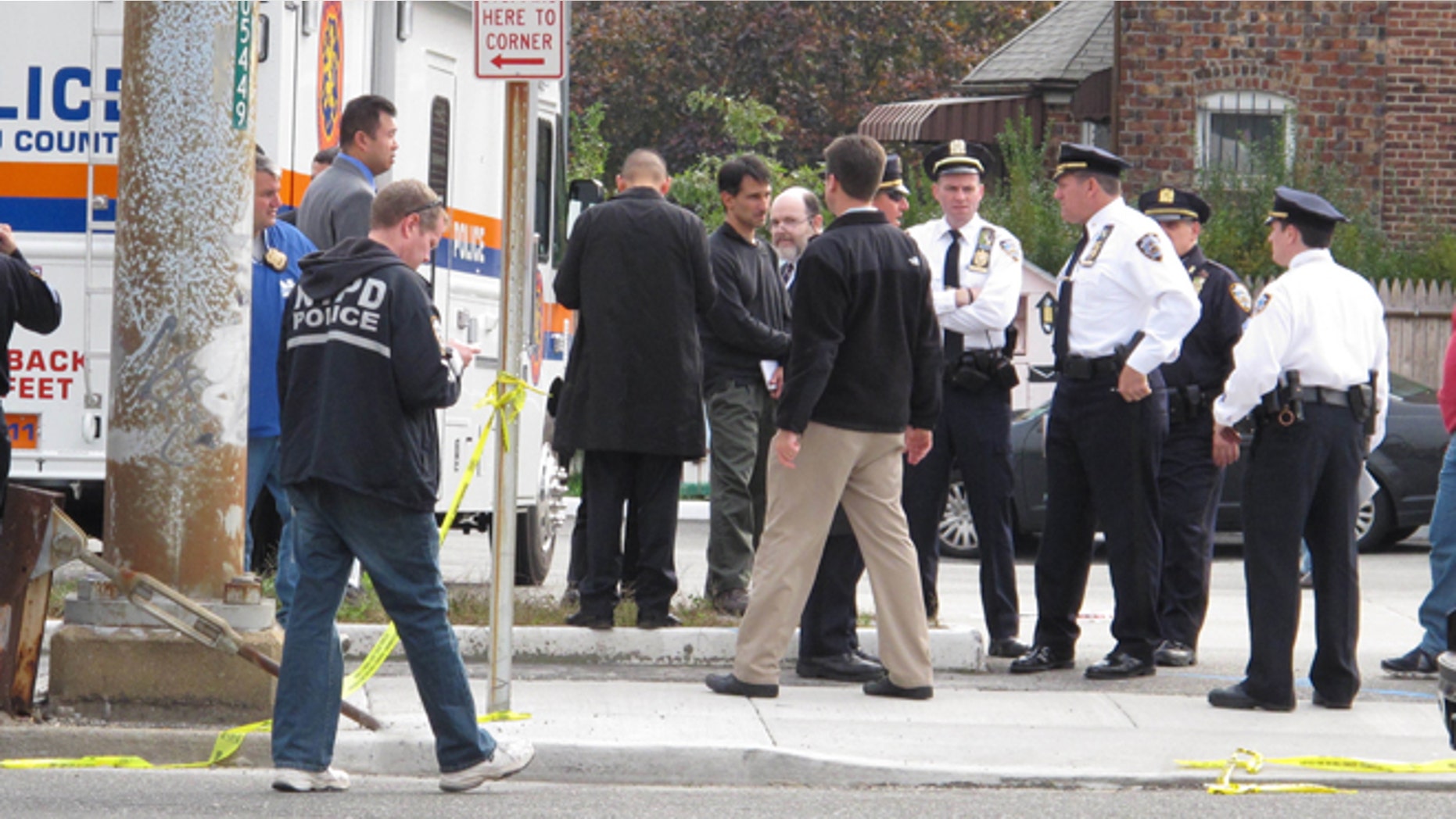 Oct. 24, 2012: Police officers investigate at the scene of a shooting in Bellerose Terrace, N.Y.. A police officer on New Yorks Long Island and another person were killed after shooting erupted Tuesday morning during what a witness described as a routine traffic stop at the New York City limits on Long Island.