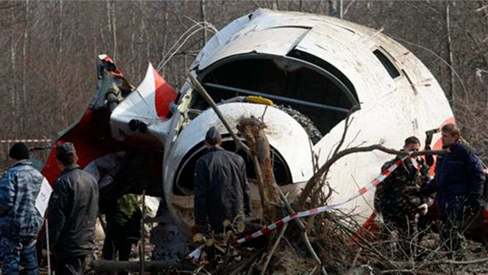 April 14, 2010: In this file picture emergency ministry workers prepare to load the wreckage of the Polish presidential plane onto a transporter just outside the Smolensk airport, western Russia.
