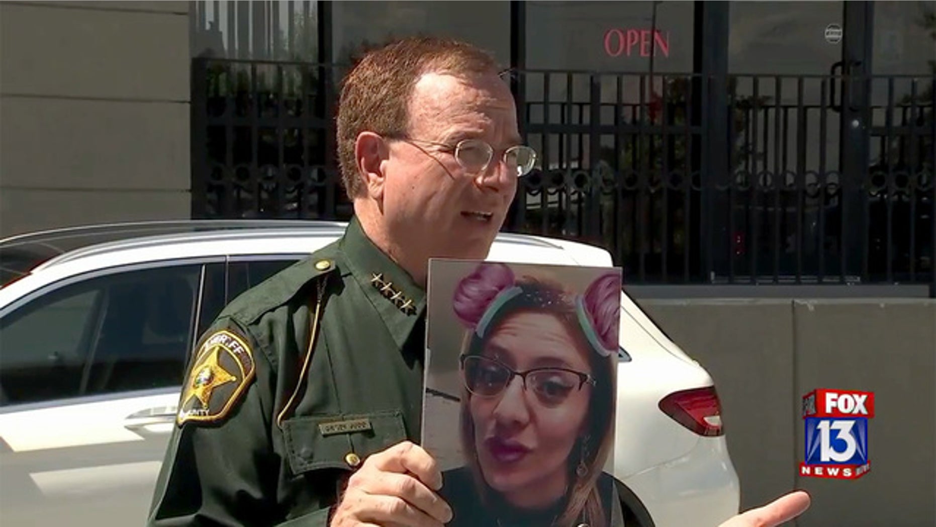 Polk County Sheriff Grady Judd, seen holding a photo of suspect Jesse Lopez, said she was operating without a medical license.