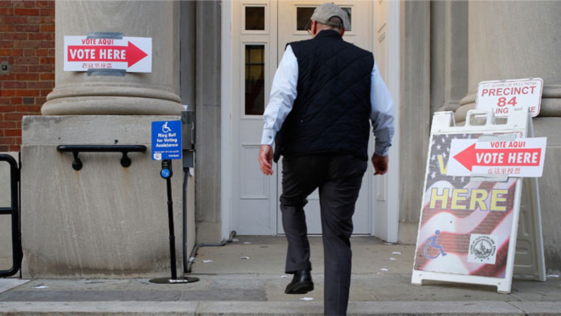 FILE: Nov. 4, 2014: A voter enters the polling place at Stuart-Hobson Middle School on Capitol Hill, in Washington, D.C.