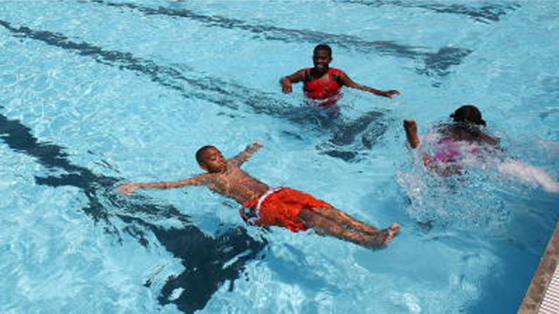 NEW YORK - JULY 03: Children swim in a new floating pool dubbed the 'Floating Pool Lady' following a press conference announcing its opening July 3, 2007 in the Brooklyn borough of New York City. The pool is anchored at the new Brooklyn Bridge Park Beach and will be free and open to the public from July 4 through Labor Day. (Photo by Mario Tama/Getty Images)