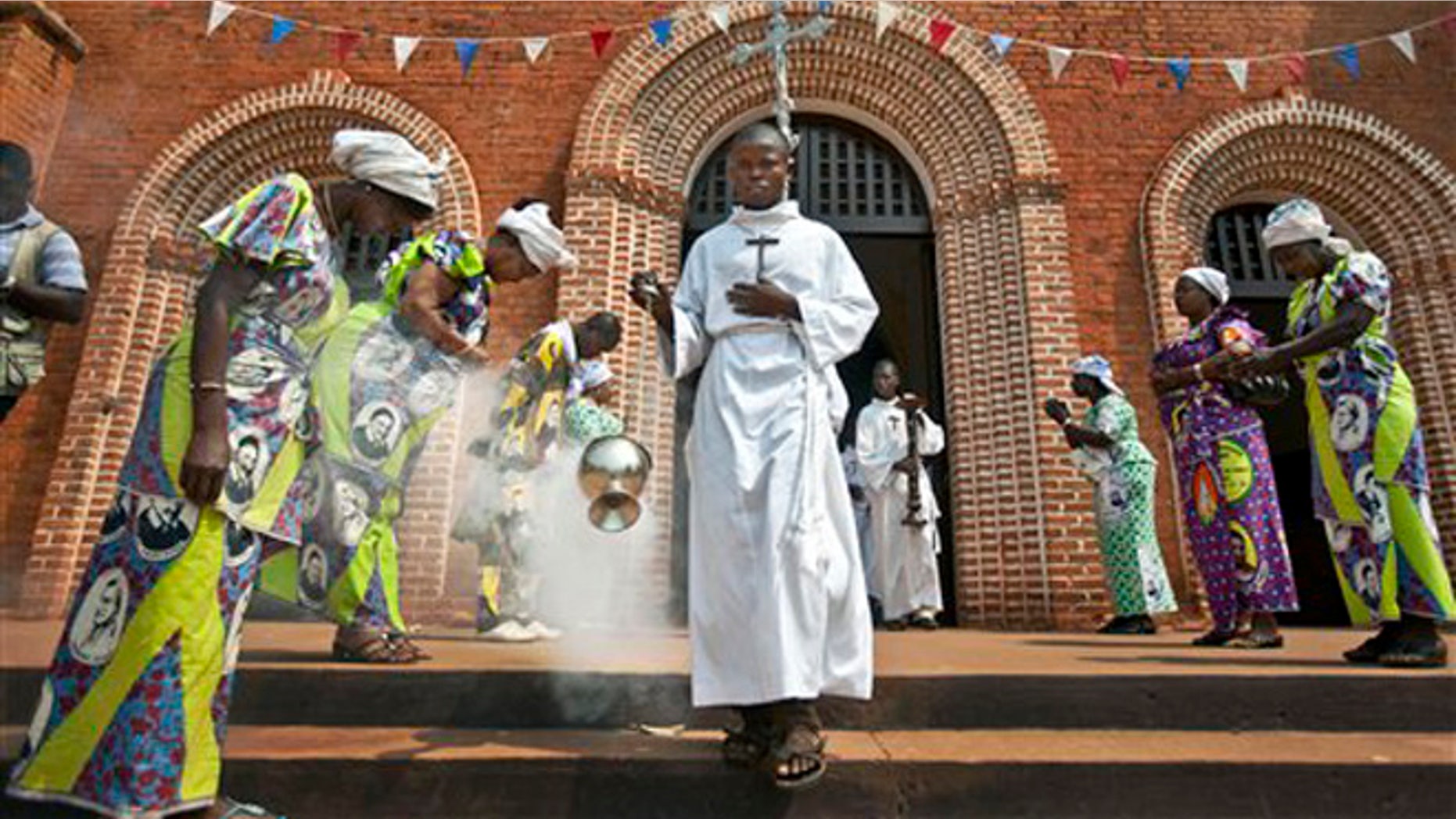 FILE - In this Sunday, Jan. 6, 2013 file photo, the thurifer swings the thurible of incense as he leads the procession out of the Notre Dame Cathedral of the Immaculate Conception at the end of the morning mass in Bangui, Central African Republic. Pope Francis follows his predecessors next week Nov. 25-30, 2015 to visit Africa whose growing numbers of Catholics are seen as a bulwark for a church seeking to broaden its appeal amid secularism, competing Christian faiths and violent extremism, in a trip that will take him to Kenya, Uganda and the Central African Republic. (AP Photo/Ben Curtis, File)