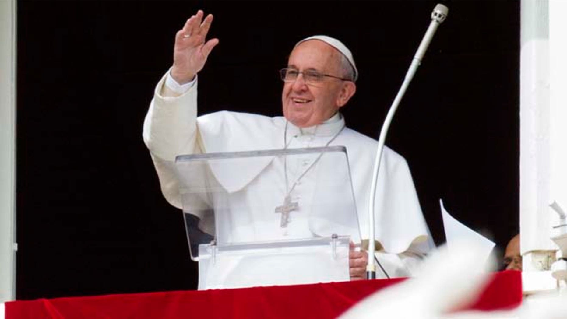 Feb. 22, 2015: Pope Francis waves to faithful from his studio window overlooking St. Peter's Square, during the Angelus noon prayer at the Vatican.