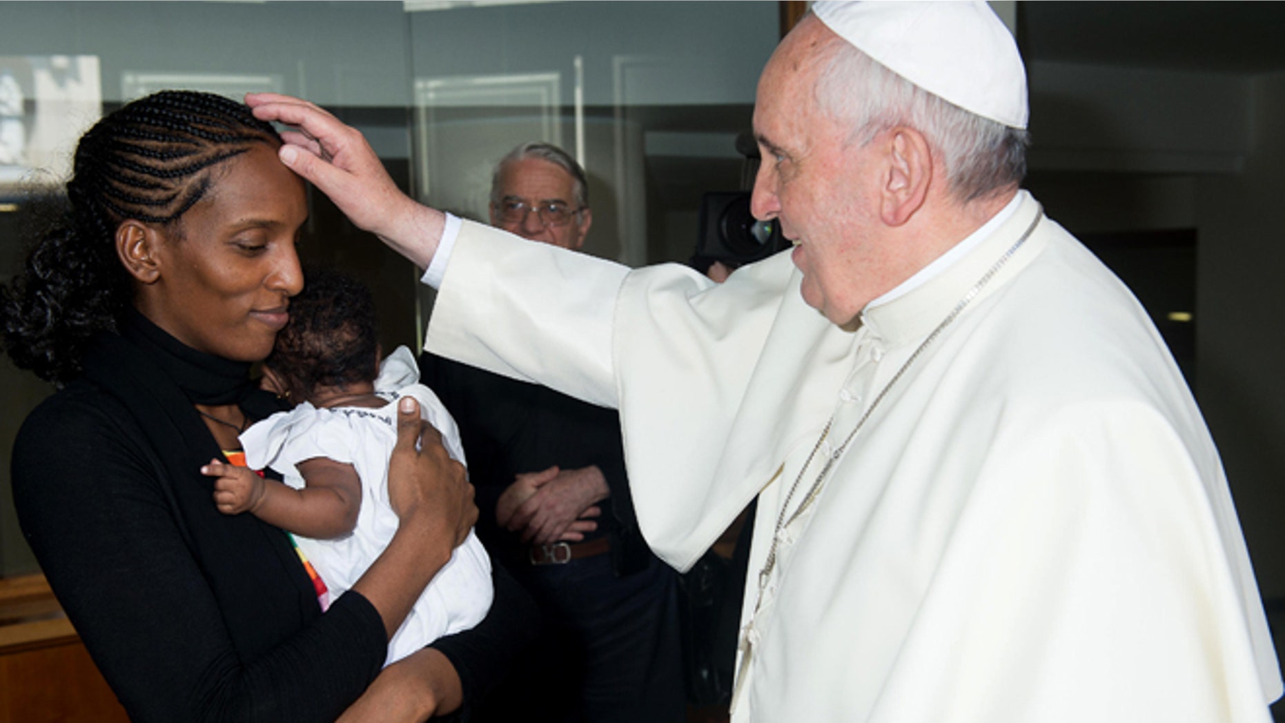 July 24, 2014: In this photo provided by the Vatican newspaper L'Osservatore Romano, Pope Francis meets Meriam Ibrahim, from Sudan, with her daughter Maya in her arms, in his Santa Marta residence, at the Vatican. The Sudanese woman who was sentenced to death in Sudan for refusing to recant her Christian faith has arrived in Italy along with her family, including the infant born in prison. (AP)